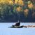 Woman finding peace by sitting on rocks extending to a lake